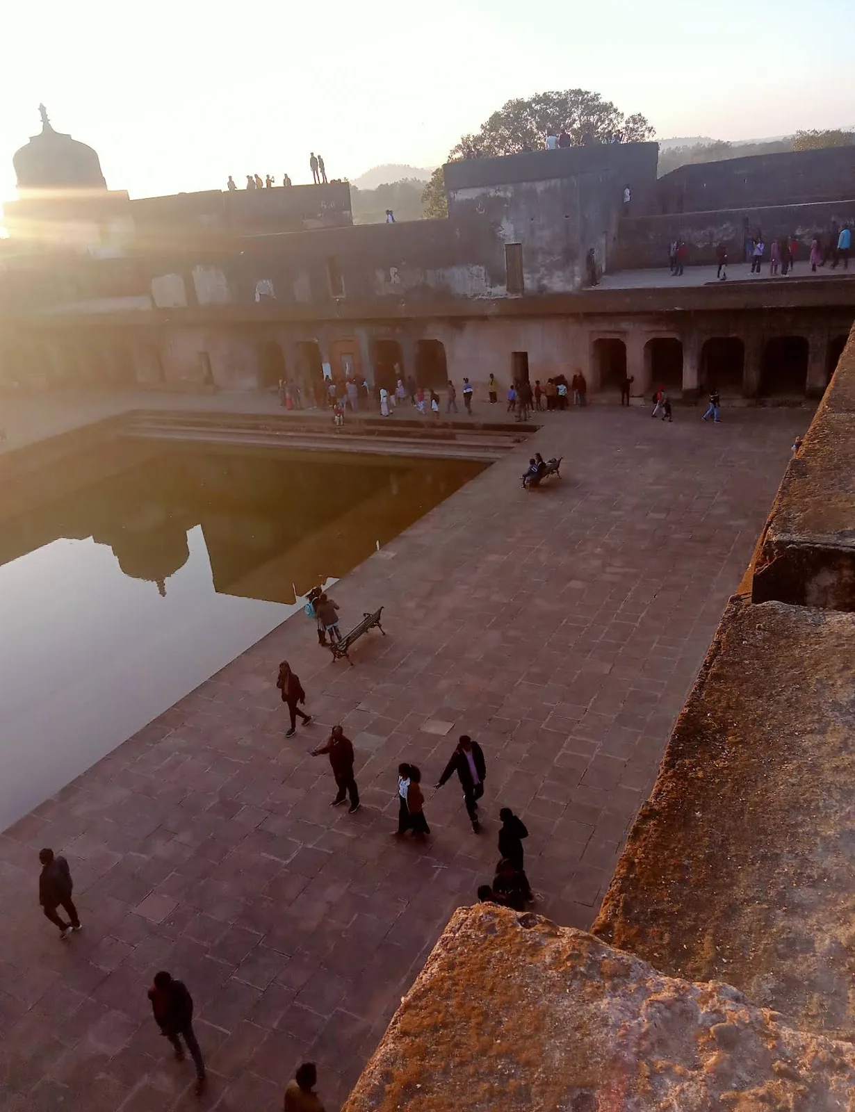 Visitors around the courtyard and tank at Moti Mahal Ramnagar